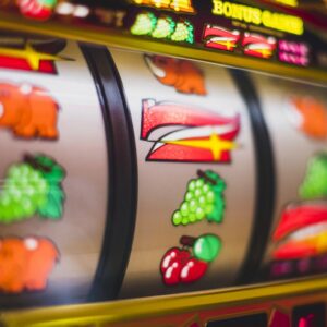 Pantalla de ordenador mostrando una slot online con rodillos temáticos y colores vibrantes en un entorno doméstico acogedor.